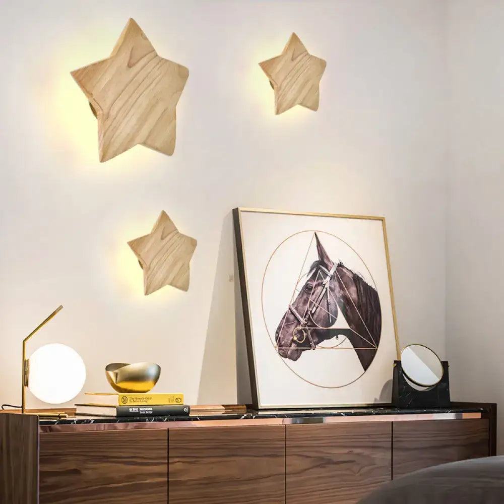 Three light-colored natural wood star wall lamps with wood grain finish for modern living room sconces