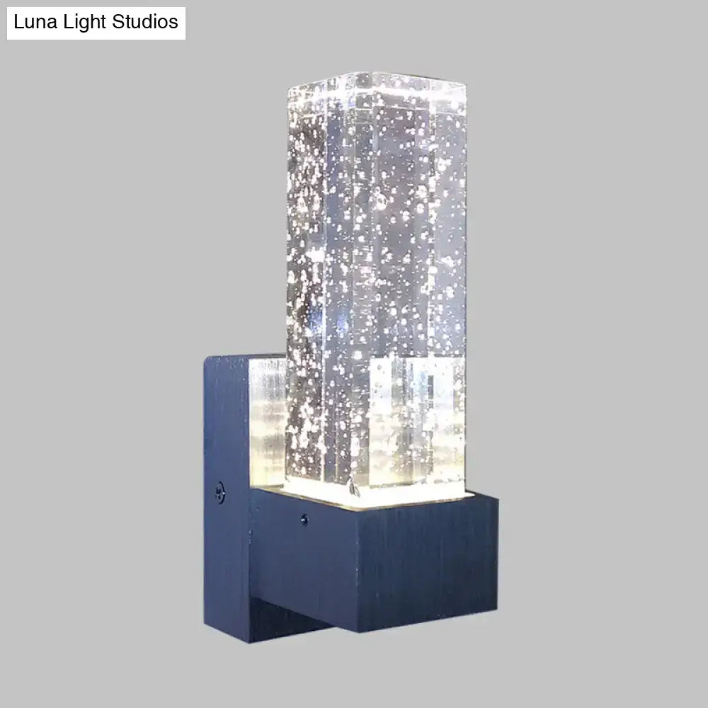Modern navy and clear crystal wall sconce with floating bubble design and compact fixture width for bedroom lighting