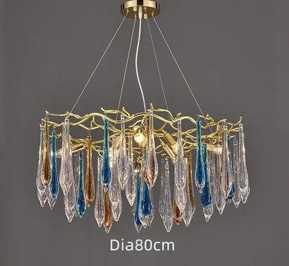 A modern nest crystal led chandelier with a golden branch frame and clear blue amber teardrop pendants for living rooms