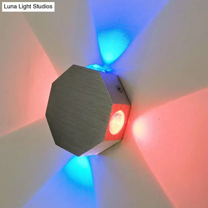 Modern octagonal wall sconce with nickel finish, wood accents, and built-in led light emitting red and blue beams