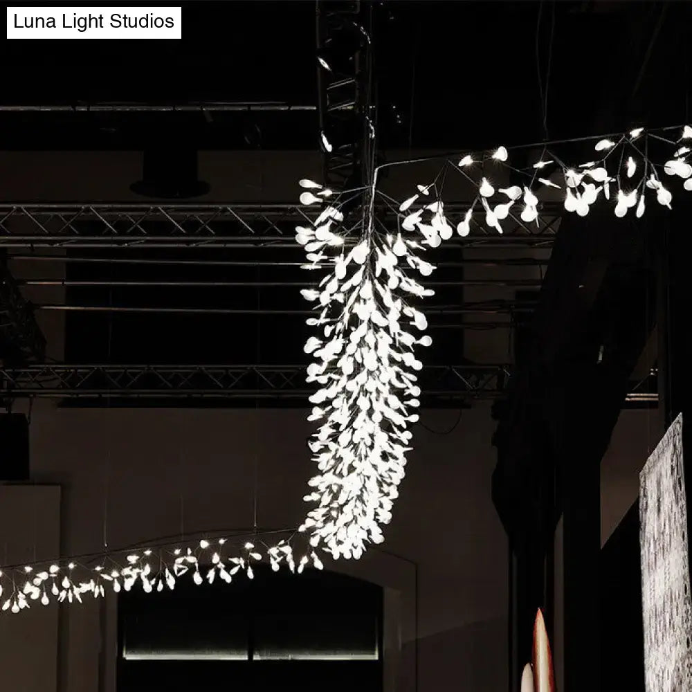 A modern aluminum island ceiling lamp with cascading white petals and nickel rose gold branching design