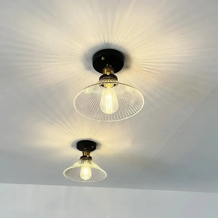 Two vintage-style black metal ceiling lamps with decorbites clear glass led ribbed shades for modern nordic kitchens