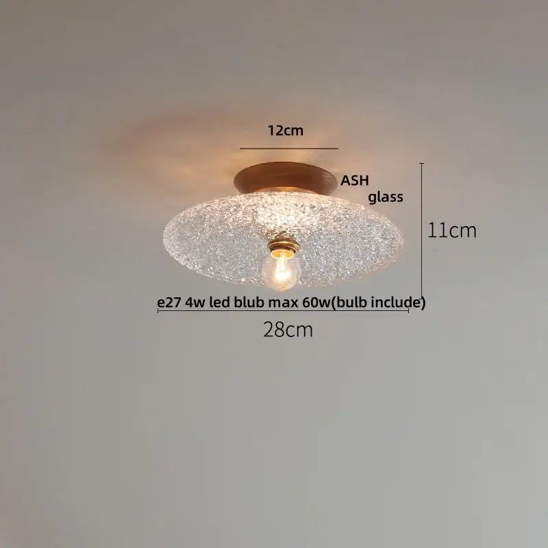 A warm-toned modern nordic ceiling lamp with decorbites clear glass led and brass-finished bulb holder