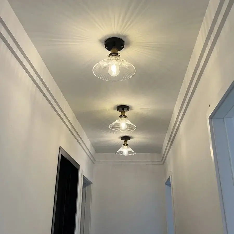 Three vintage-style ceiling lamps with brass fixtures and decorbites clear glass led shades for modern nordic kitchens