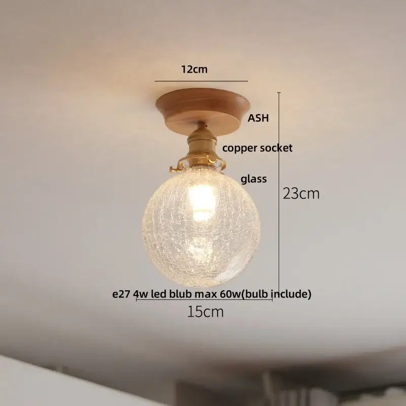 A warm-toned decorbites clear glass led ceiling lamp with crackled globe, brass copper socket, and ash wood mount