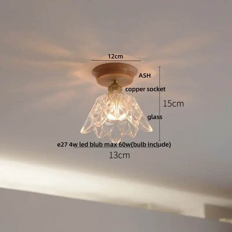Modern nordic clear glass led ceiling lamp with faceted glass pendant, copper socket, and wooden base by decorbites