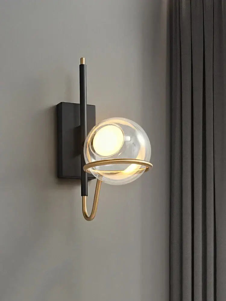 Modern nordic pendant light with a black rectangular backplate brass accent ring and decorbites clear glass ball globe