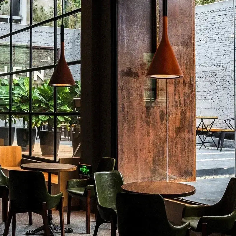 Rust-colored modern nordic black metal pendant light with conical matte design complements industrial café decor