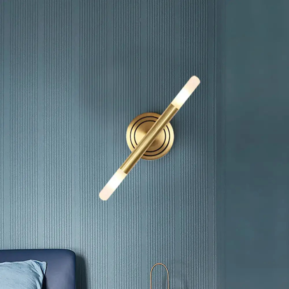 Modern Nordic brass finish wall sconce with gold-toned minimalist cylindrical design and frosted glass diffuser for bedrooms