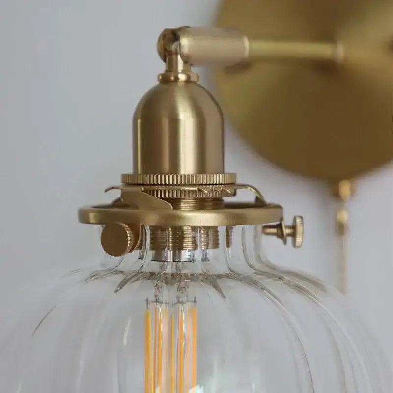 Modern nordic brass glass ball wall lamp with ribbed glass shade and exposed filament bulb for bedroom decorbites glass ball