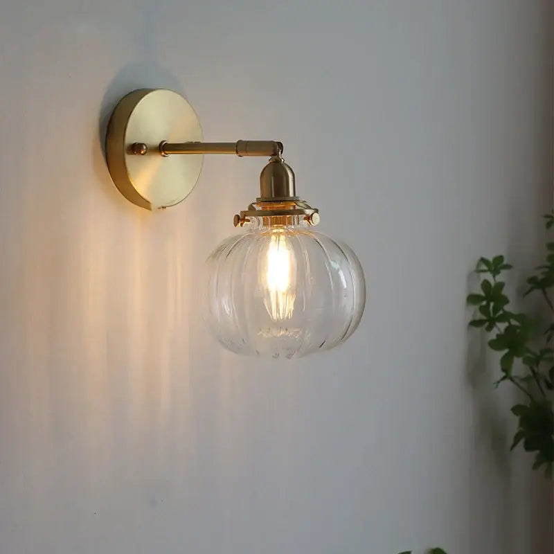 Modern nordic brass glass ball wall lamp with clear ribbed glass globe and exposed filament bulb for bedroom decorbites glass ball sconce