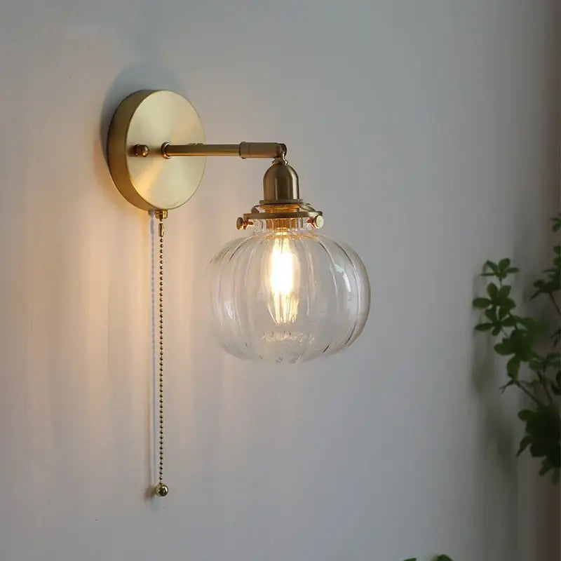Modern nordic brass glass ball wall lamp with ribbed clear globe and exposed filament bulb for bedroom decorbites glass ball