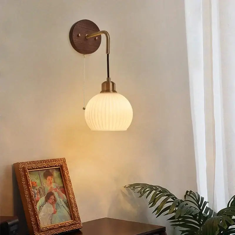 Modern nordic copper adjustable led wall light with warm-toned ribbed glass globe and brass finish arm decorbites copper adjustable