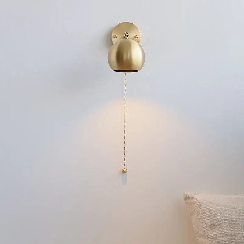 Modern nordic gold-finished spherical copper wall light with pull chain switch and decorative ball for bedroom decorbites copper wall light