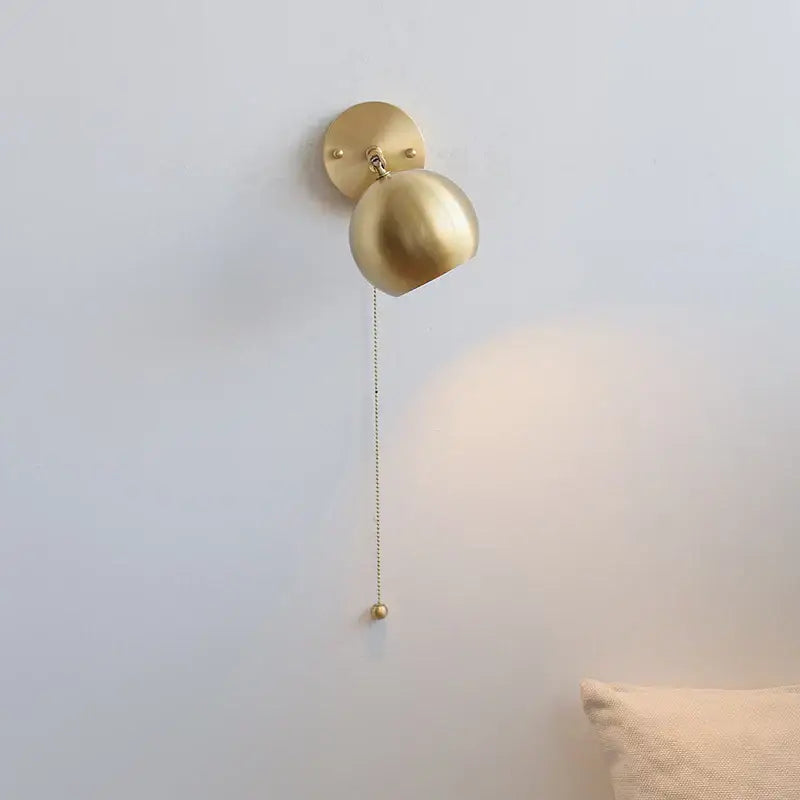 Modern nordic gold-finished spherical copper wall light with pull chain switch and decorative ball for bedroom decorbites copper wall light