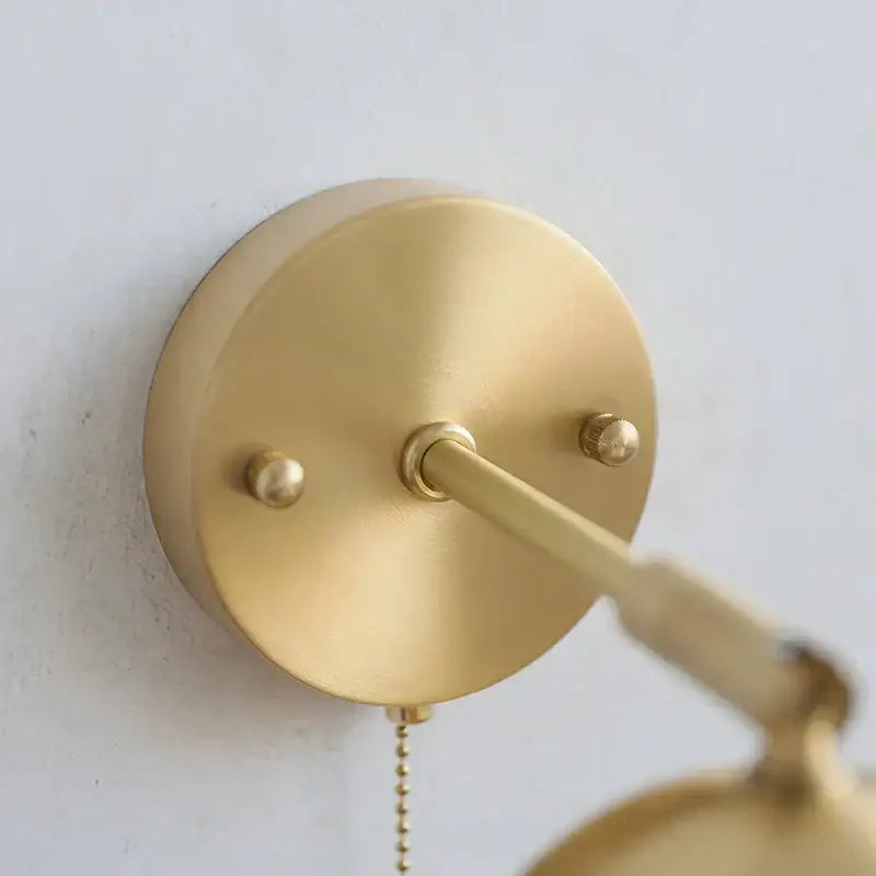 Modern nordic gold-finished brass wall light with adjustable arm and pull chain switch for bedroom decorbites copper wall light