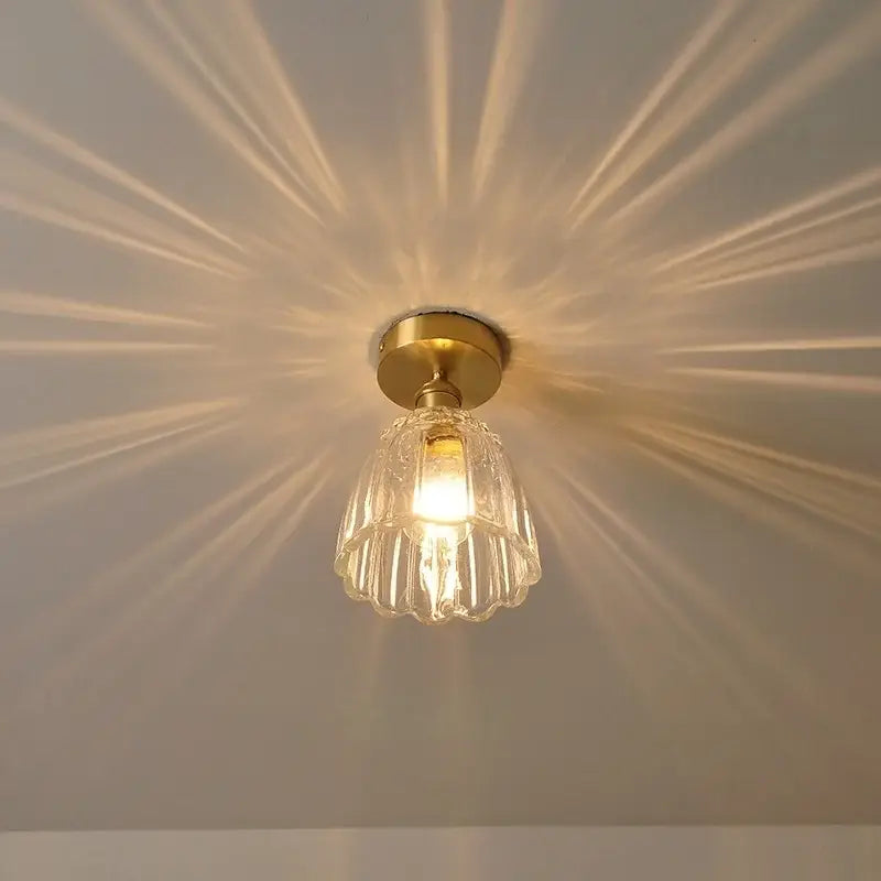 Modern nordic clear glass flower led ceiling light with brass finish for bedroom featuring faceted pendant design