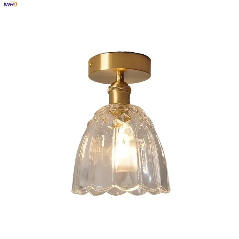 A clear faceted glass flower led pendant light with gold metal ceiling mount for modern nordic bedroom use