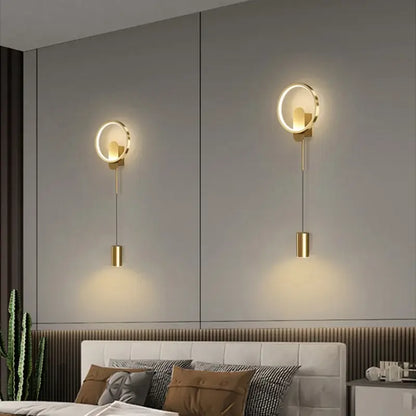 Modern nordic gold led wall light featuring circular gold-toned wall lamp with sleek hanging cylindrical fixtures by decorbites