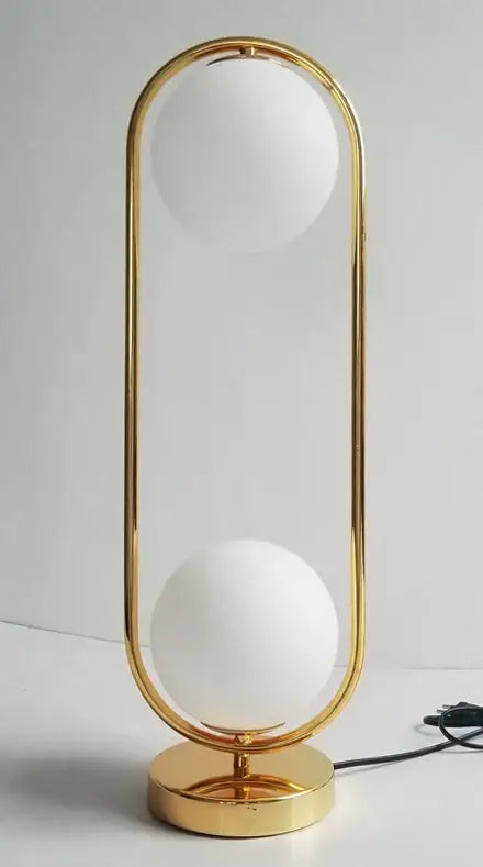 Modern Nordic LED desk lamp with decorbites golden body glass frame and two frosted white spherical shades