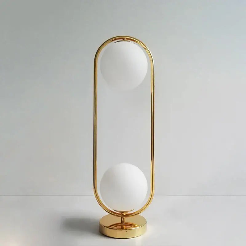 Modern nordic golden body glass led desk lamp with gold-toned oval frame and two frosted white spherical shades
