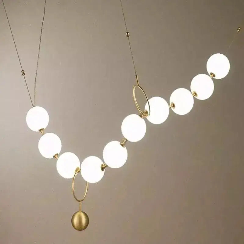 Modern nordic led pendant lamp with glowing white spherical bulbs and gold-toned metal rings for dining room decorbites nordic led
