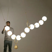 Modern nordic led pendant lamp with frosted white spherical bulbs and gold metal rings for dining room decorbites nordic led