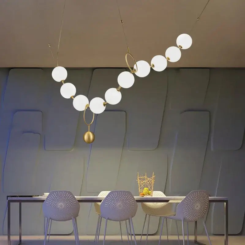 A modern nordic led pendant lamp with white glass globes and gold metal rings ideal for dining room decorbites nordic led