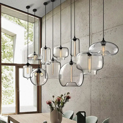Modern nordic polished chrome pendant light with clear bulbous glass shades and exposed led filament bulbs for kitchen use