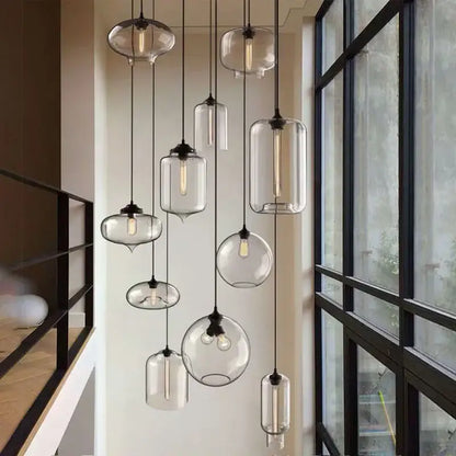 A modern nordic clear glass pendant light with polished chrome fixtures and led filament bulbs for kitchen use