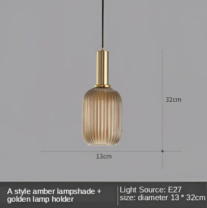A sleek amber glass led pendant light with golden metal holder and vertical ridges, perfect for dining room use