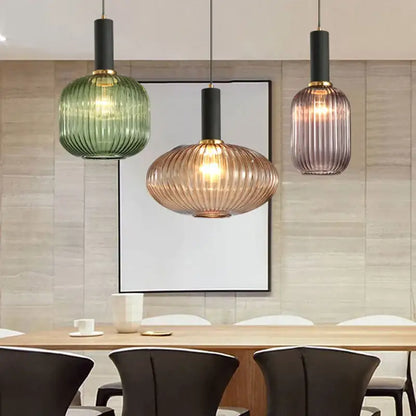 Three modern nordic pendant lights with ribbed green amber and purple glass led shades for dining room lighting