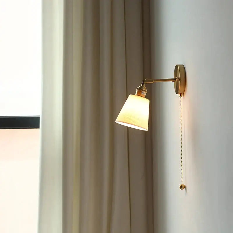 Modern nordic ceramic wall lights with warm brass adjustable arm and off-white fabric shade for bedroom decorbites ceramic wall