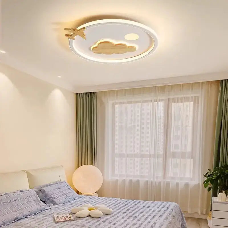 Modern nordic white decorbites cloud lamp with wooden cloud and airplane cutouts in warm tones for bedroom lighting