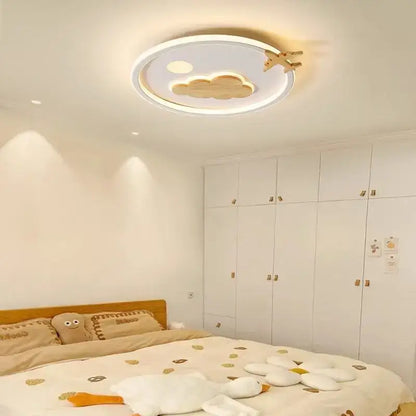 Modern nordic decorbites cloud lamp with white frame wooden cloud and airplane cutouts illuminated by warm light