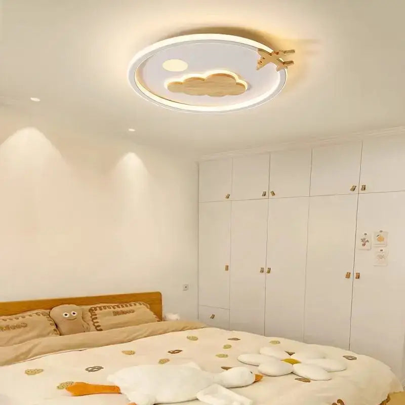 Modern nordic decorbites cloud lamp with white frame wooden cloud and airplane cutouts illuminated by warm light