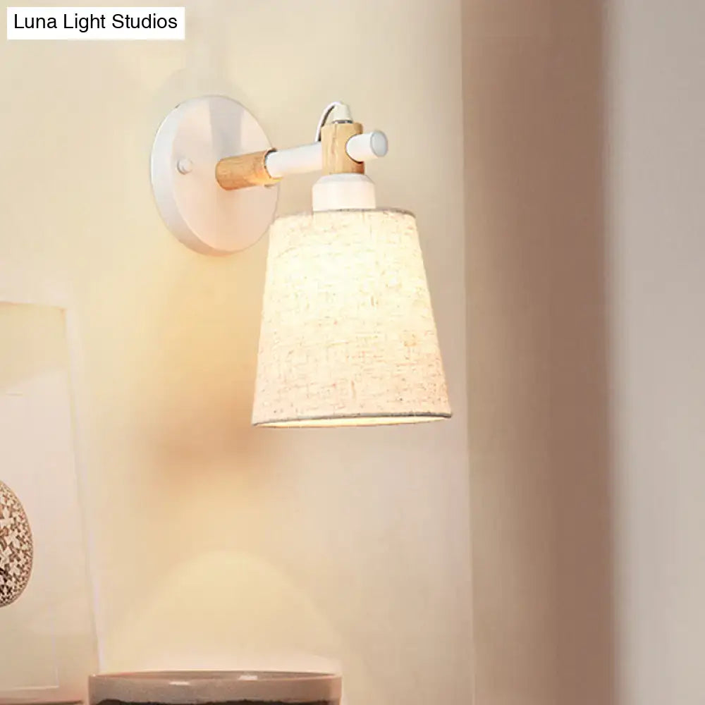 Modern nordic wood wall lamp with light wood arm and textured off-white horn shade featuring white circular base