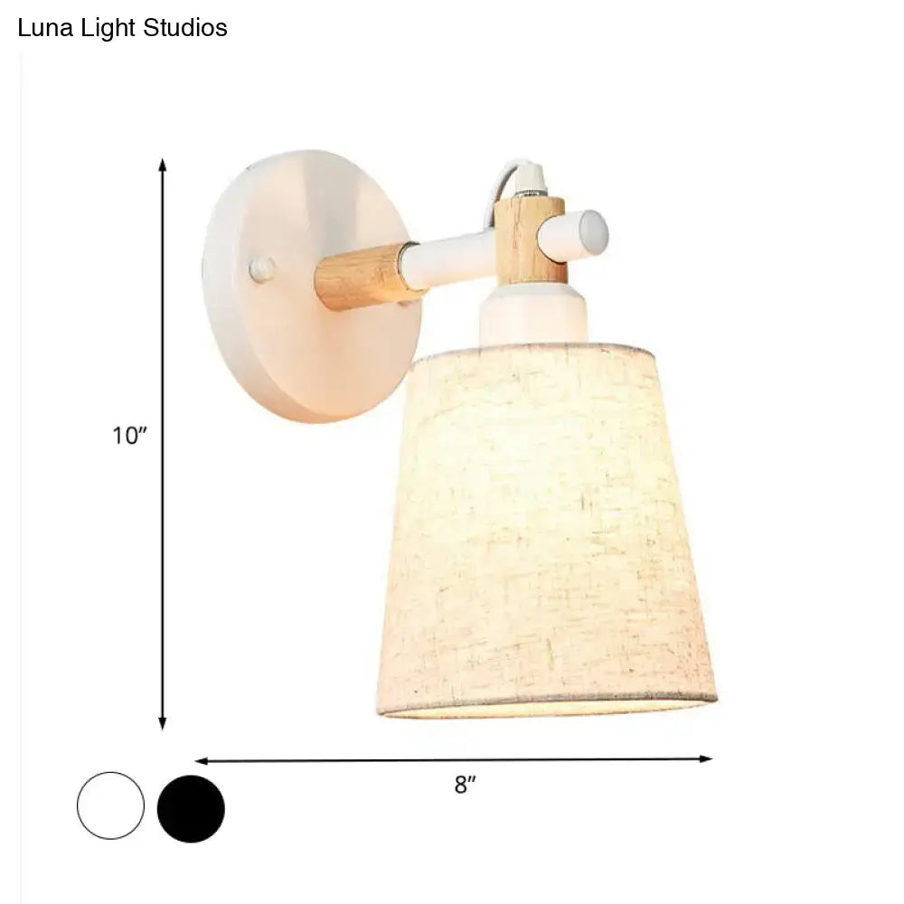Modern Nordic wood wall lamp with horn shade featuring a white circular base and beige fabric shade for bedroom use