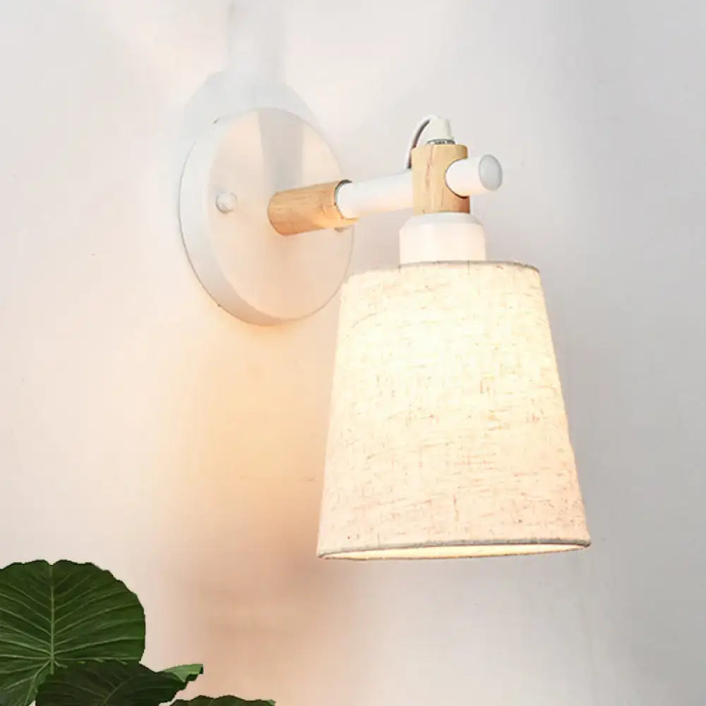 Modern Nordic wood wall lamp with white circular base, light wood arm, beige horn shade for bedroom sconce lighting