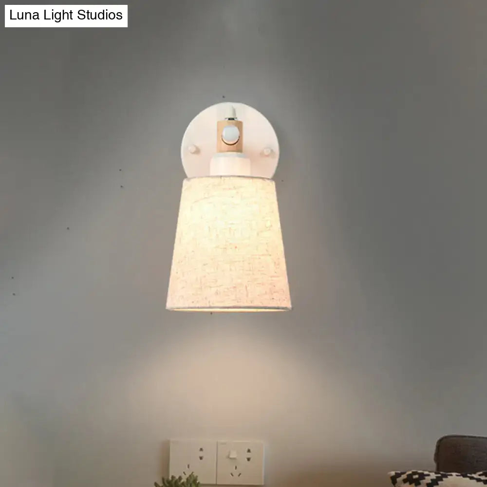Modern nordic wall lamp with textured beige horn shade, wooden accents, and light bulb, ideal for bedroom use