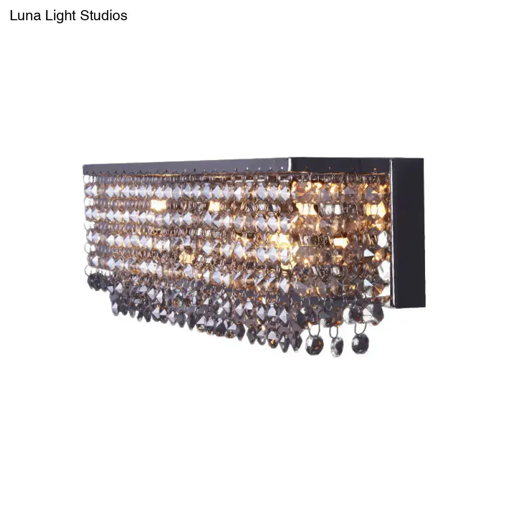 Modern octagon crystal wall light with chrome finish featuring a black metal frame and cascading smoky crystal beads