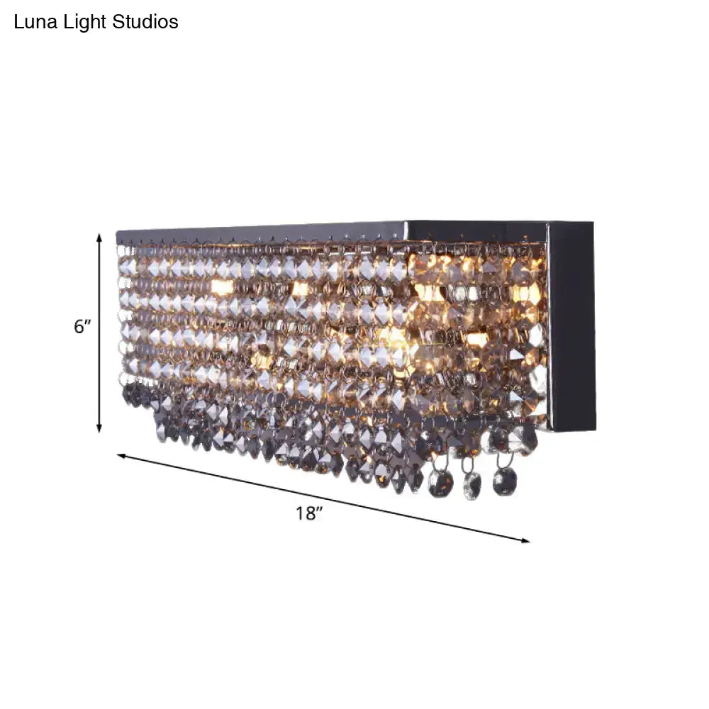 Modern octagon crystal wall light with chrome finish features a black rectangular frame and cascading smoky crystal beads