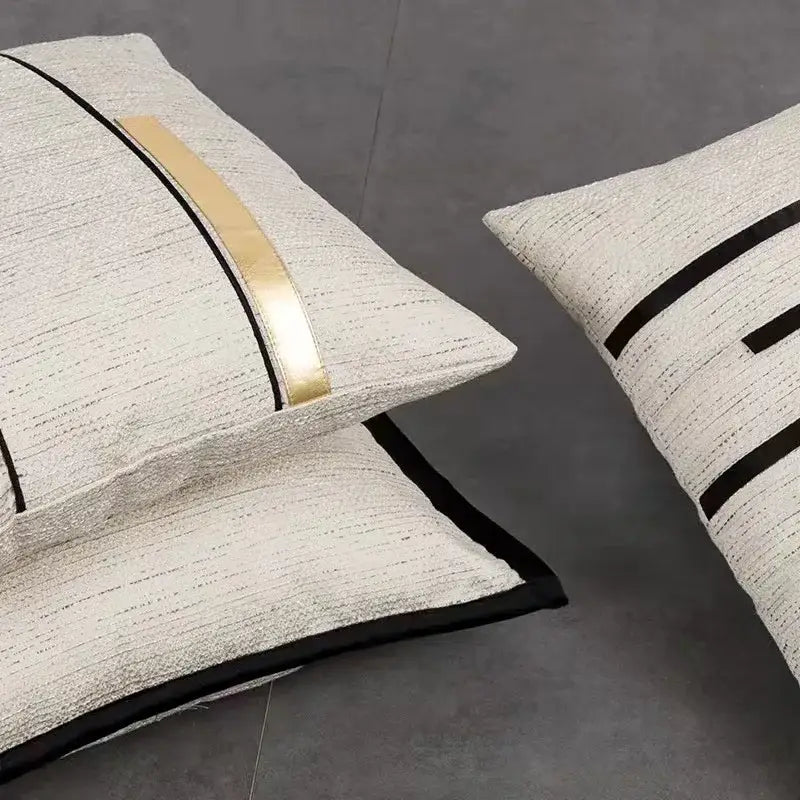 Cream-colored textured cushion cover with sleek black stripe jaquard and gold geometric accents for modern decorbites decor