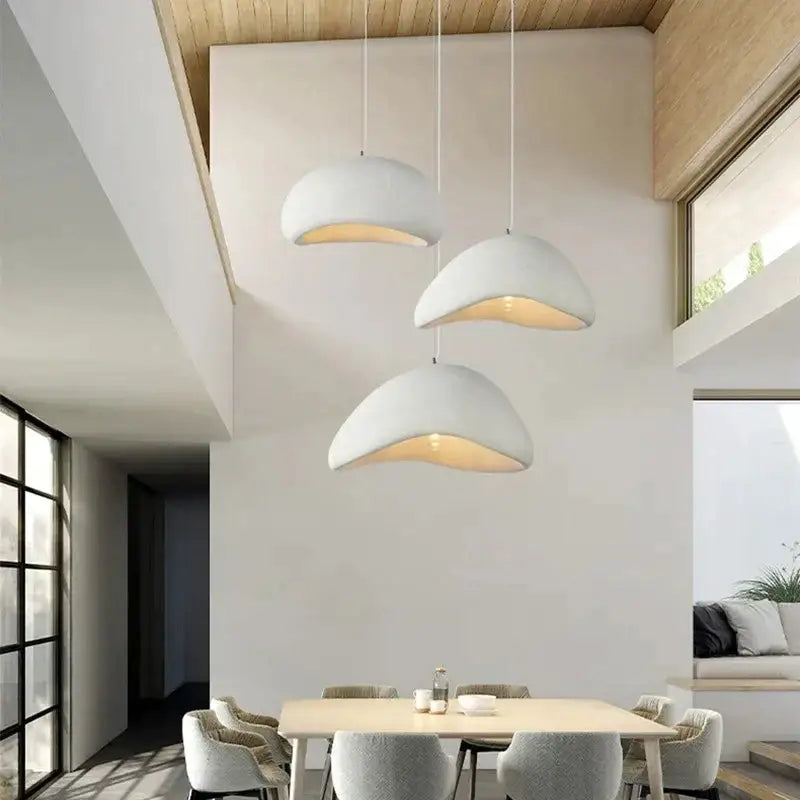 Modern off white ceramic pendant light with warm led chandelier glow hanging in dining room by decorbites handmade modern