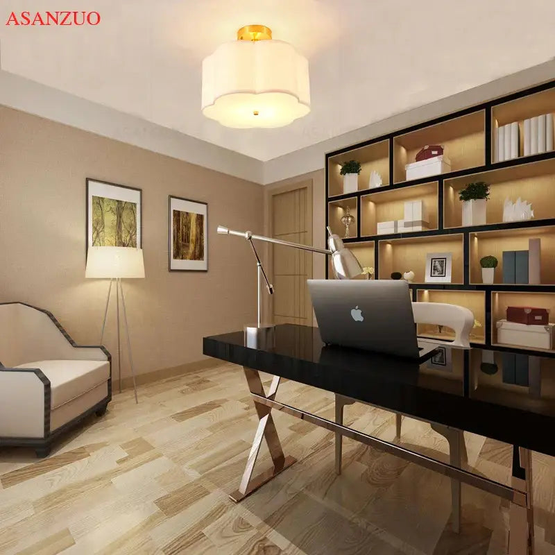 Black glossy desk with chrome x shaped legs paired with modern off white textured decorbites copper acrylic ceiling light