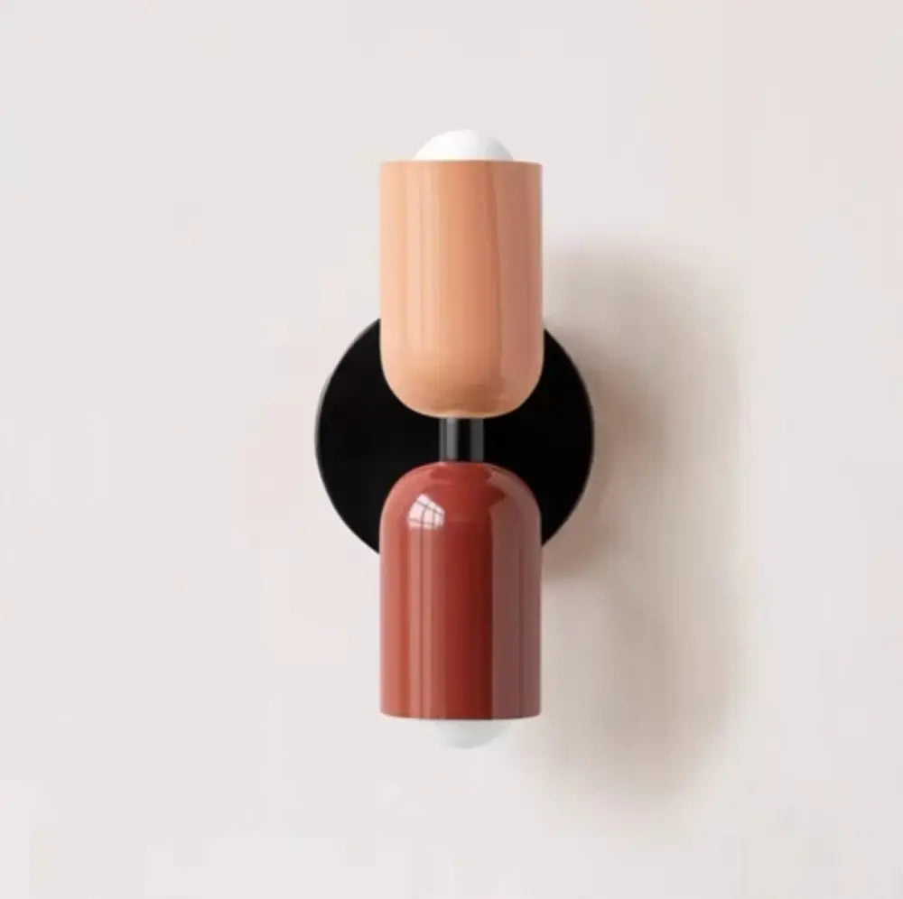 Modern cream double head wall lamps featuring two-toned matte peach and glossy terracotta cylinders on black base