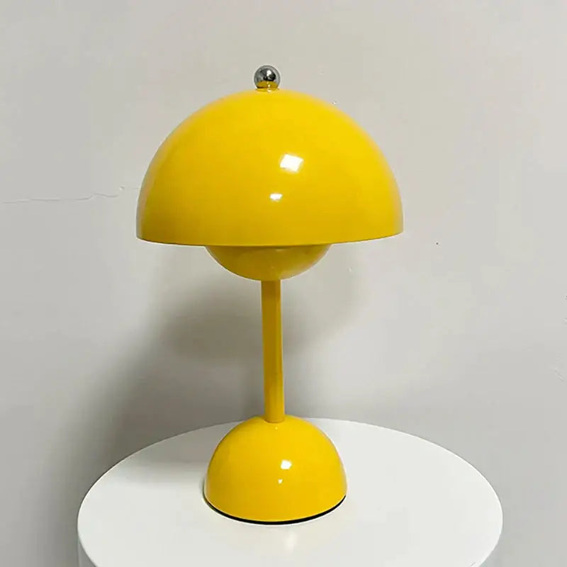 Modern orange bud metal desk lamp features a vibrant yellow flower dome design with polished silver sphere accent decorbites bud metal