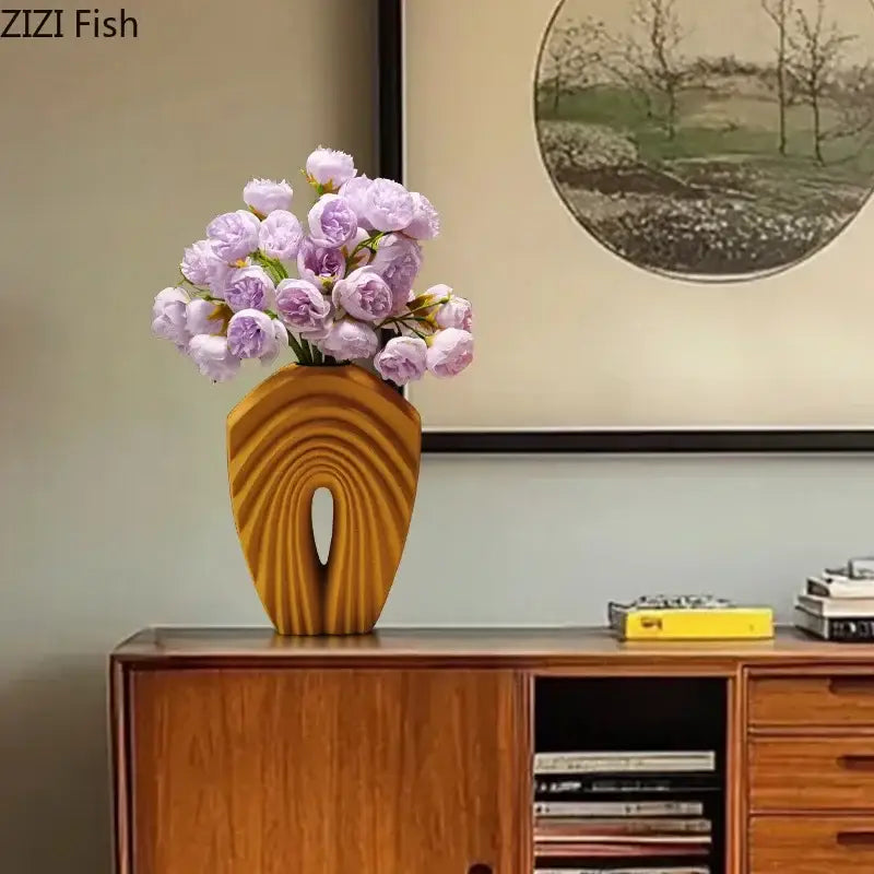 A warm-toned wooden geometric ceramic vase with a curved ribbed design holding lavender peonies for decorbites decorbites geometric ceramic