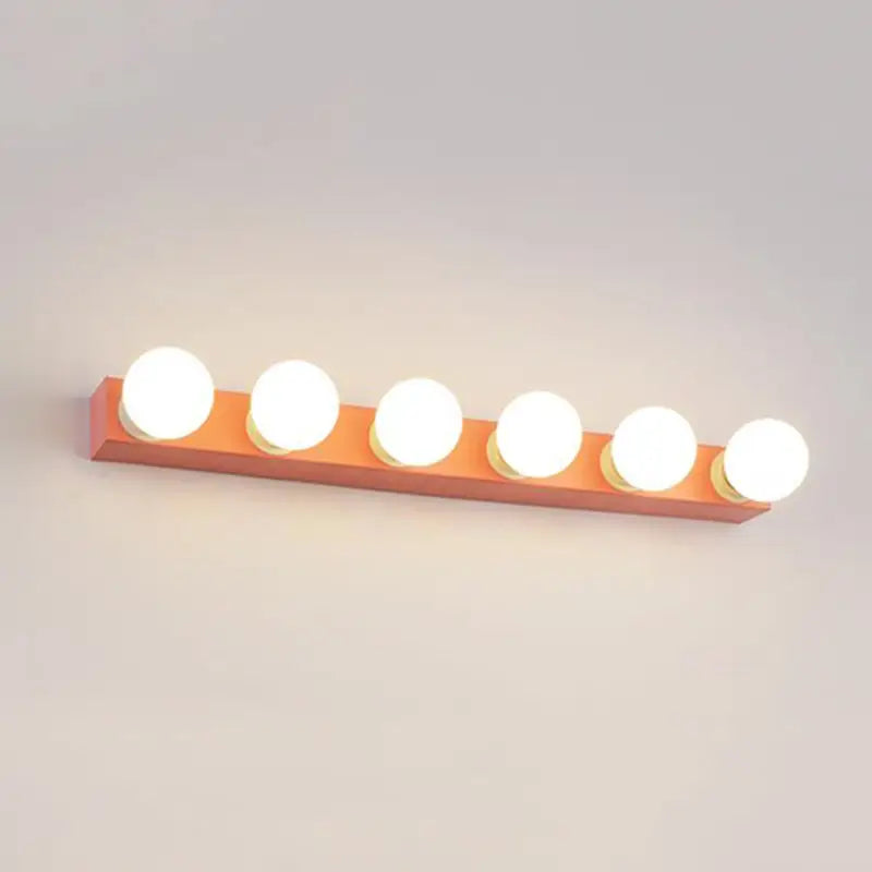 Modern orange rectangular vanity light fixture with six glowing white spherical bulbs for bedroom use