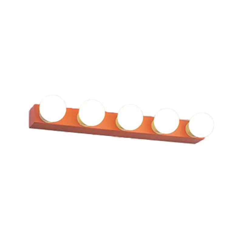 Modern orange rectangular vanity light fixture with five round white bulbs designed for bedroom use